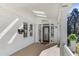 Inviting front porch with white brick, skylights, ceiling fan and decorative glass front door at 232 Westminster Ne Dr, Atlanta, GA 30309