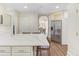 Open kitchen view with quartz countertop, seating, and stainless steel refrigerator at 232 Westminster Ne Dr, Atlanta, GA 30309