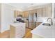 Bright kitchen with stainless steel appliances, white countertops, and light wood cabinets, providing functionality and a modern design at 232 Westminster Ne Dr, Atlanta, GA 30309