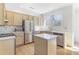 Well-lit kitchen features stainless steel appliances, white countertops, and light wood cabinets, offering both style and functionality at 232 Westminster Ne Dr, Atlanta, GA 30309