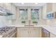 Well-lit kitchen showcasing white countertops, stainless steel appliances and a garden view at 232 Westminster Ne Dr, Atlanta, GA 30309