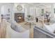 Elegant living room featuring a fireplace, coffered ceiling, and neutral color palette. A cozy space for gatherings at 232 Westminster Ne Dr, Atlanta, GA 30309