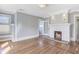 Spacious living room features decorative fireplace, hardwood floors, and windows providing natural light for a warm atmosphere at 232 Westminster Ne Dr, Atlanta, GA 30309