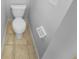 Bright bathroom features a standard toilet and neutral tile floors at 2412 Cheyenne Ln, Lawrenceville, GA 30044