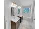 Bright bathroom featuring dual vanities and a bathtub with tile surround at 2412 Cheyenne Ln, Lawrenceville, GA 30044