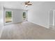 Large primary bedroom with a ceiling fan, neutral walls and carpet at 2412 Cheyenne Ln, Lawrenceville, GA 30044