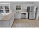 Well-lit kitchen with white cabinetry and stainless steel appliances at 2412 Cheyenne Ln, Lawrenceville, GA 30044