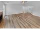 Spacious living room featuring wood flooring, fireplace and ceiling fan at 2412 Cheyenne Ln, Lawrenceville, GA 30044