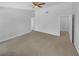 Large primary bedroom with a ceiling fan, neutral walls and carpet at 2412 Cheyenne Ln, Lawrenceville, GA 30044