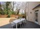 View of a backyard with a new deck, a wooden fence, and mature trees providing a private outdoor space at 3350 Fieldwood Se Dr, Smyrna, GA 30080