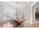 Elegant dining room with hardwood floors, modern lighting, and natural light at 3350 Fieldwood Se Dr, Smyrna, GA 30080