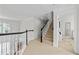 Light-filled hallway with stairs leading to a main floor with windows and elegant trim at 3350 Fieldwood Se Dr, Smyrna, GA 30080