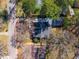 Birds eye view of a home with a detached garage, mature trees, a driveway, and surrounding neighborhood streets at 827 Derrydown Way, Decatur, GA 30030