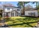 Lush backyard featuring a well-manicured lawn, hot tub, screened in porch and detached garage, perfect for entertaining at 827 Derrydown Way, Decatur, GA 30030