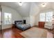 Bright bedroom with hardwood floors, natural light, and vaulted ceiling detail at 827 Derrydown Way, Decatur, GA 30030