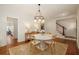 Elegant dining room with hardwood floors, chandelier, and natural light at 827 Derrydown Way, Decatur, GA 30030