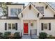 Charming home featuring a bright red front door and black shutters, complemented by meticulous landscaping and a welcoming entrance at 827 Derrydown Way, Decatur, GA 30030