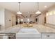 Open kitchen view showcasing a large island with a sink and pendant lighting, seamlessly connected to the adjacent living room at 827 Derrydown Way, Decatur, GA 30030