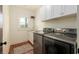 Bright laundry room with modern washer and dryer, sink, and white cabinets, offering convenience and storage at 827 Derrydown Way, Decatur, GA 30030