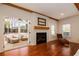 Cozy living room with a brick fireplace and access to a screened-in porch, providing a seamless blend of indoor and outdoor living at 827 Derrydown Way, Decatur, GA 30030