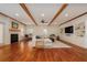 Spacious living room featuring hardwood floors, a cozy fireplace, built-in shelving, and exposed wood beams, creating an inviting atmosphere at 827 Derrydown Way, Decatur, GA 30030