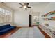 Spacious playroom with a ceiling fan, storage shelves and a large window at 827 Derrydown Way, Decatur, GA 30030