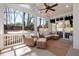 Inviting screened porch featuring comfortable wicker seating and an outdoor ceiling fan, perfect for relaxation at 827 Derrydown Way, Decatur, GA 30030