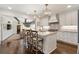 Open kitchen with marble countertops, pendant lighting, stainless steel appliances, and wooden barstools at 1015 Peachtree Battle Cir, Atlanta, GA 30327