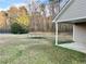 Large backyard featuring green grass and trees at 2703 Regal Cir, Conyers, GA 30012