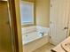Relaxing bathroom with soaking tub, white cabinets, and tile floors at 2703 Regal Cir, Conyers, GA 30012