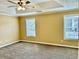 Bedroom boasting a ceiling fan and two bright windows at 2703 Regal Cir, Conyers, GA 30012
