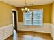 Dining room with wood floors, wainscoting, and modern chandelier at 2703 Regal Cir, Conyers, GA 30012