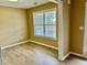 Bright dining room featuring wood-look flooring and a large window allowing natural light at 2703 Regal Cir, Conyers, GA 30012