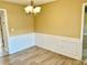Dining area with wood floors, wainscoting, and a modern light fixture at 2703 Regal Cir, Conyers, GA 30012