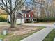 Two-story red brick home with a two-car garage, front porch, and basketball hoop in the driveway at 2703 Regal Cir, Conyers, GA 30012