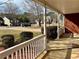 Cozy front porch with classic white railings offers views of the quiet neighborhood street at 2703 Regal Cir, Conyers, GA 30012
