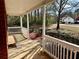 Inviting front porch with white railings and columns, perfect for enjoying the view of the landscaped yard at 2703 Regal Cir, Conyers, GA 30012