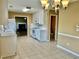 Spacious eat-in kitchen with tile flooring, white cabinets, and modern appliances at 2703 Regal Cir, Conyers, GA 30012