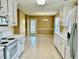 Bright kitchen with white appliances and ample counter space, leading to an adjacent dining area with natural light at 2703 Regal Cir, Conyers, GA 30012