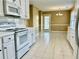 Bright kitchen with white cabinets, tile floors, white appliances, and eat-in dining area at 2703 Regal Cir, Conyers, GA 30012