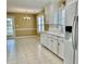 Charming kitchen features white cabinetry, tile flooring, and stainless steel appliances at 2703 Regal Cir, Conyers, GA 30012