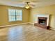 Cozy living room featuring wood-look floors and a brick fireplace, perfect for relaxing on chilly evenings at 2703 Regal Cir, Conyers, GA 30012