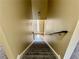 Carpeted stairs leading to upper level with wood railing and neutral paint at 2703 Regal Cir, Conyers, GA 30012