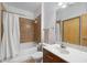 Well-lit bathroom featuring a shower-tub combo, modern sink, and vanity at 898 Oak Sw St # 3222, Atlanta, GA 30310