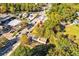 An aerial view captures the property surrounded by greenery, adjacent to commercial buildings and a busy street at 1653 Richmond Se Ave, Atlanta, GA 30315