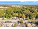 Aerial shot showcases homes near commercial parking, framed by lush trees at 1653 Richmond Se Ave, Atlanta, GA 30315