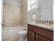 This bathroom features tile details in the shower, granite countertop, and a large mirror at 1800 Morning Glory Ne Ln, Atlanta, GA 30324