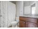 This bathroom features a decorative shower curtain, granite countertop, and neutral color palette at 1800 Morning Glory Ne Ln, Atlanta, GA 30324