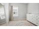 This bedroom has a bright window, neutral walls, and a dresser perfect for decorating at 1800 Morning Glory Ne Ln, Atlanta, GA 30324