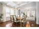 Open dining space with exposed beam ceiling adjacent to living area at 1800 Morning Glory Ne Ln, Atlanta, GA 30324